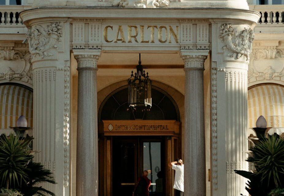 An ornate entrance of the luxury Carlton Hotel in Cannes, France, showcasing grandeur and architectural beauty.